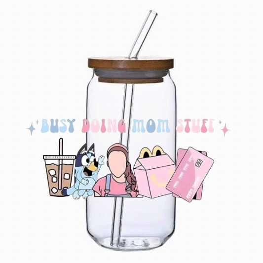 Clear tumbler with busy doing mom stuff cup wrap, bamboo lid, and straw on a white background.