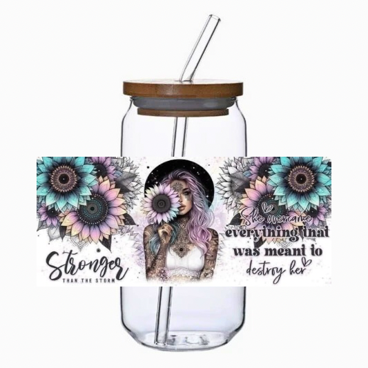 Glass tumbler with bamboo lid and straw, featuring artistic designs and text on a white background.