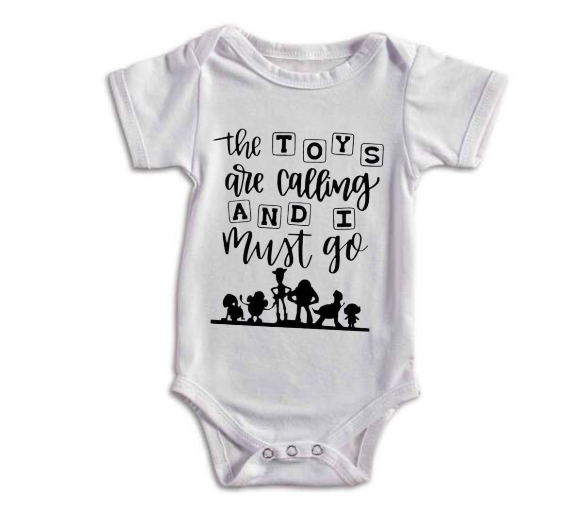 White baby onesie with black text and toy figures on a white background