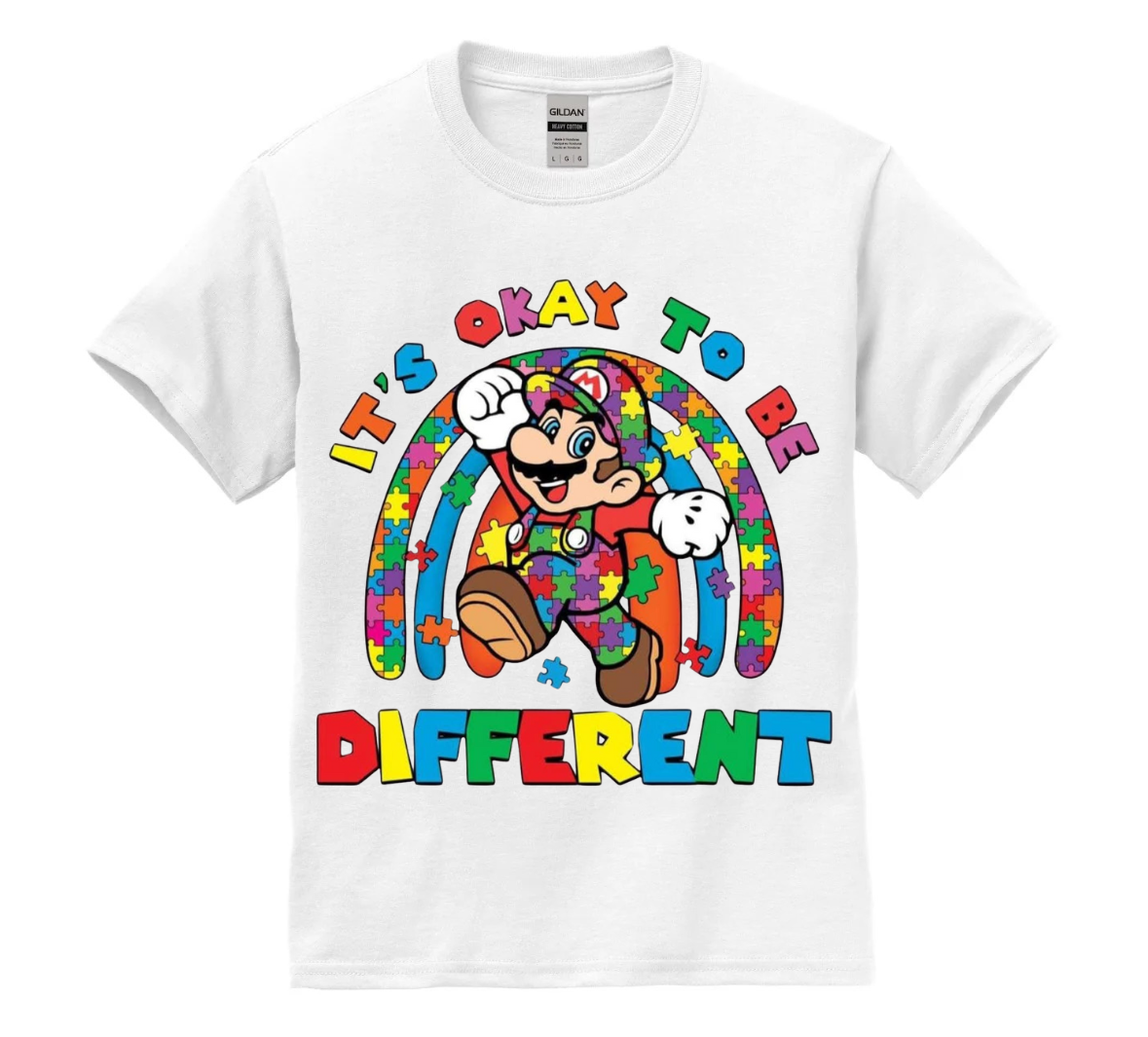 White t-shirt with colorful character design and text 'It's okay to be different' on a white background