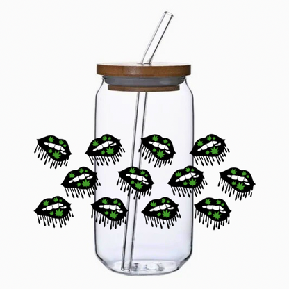Clear glass tumbler with bamboo lid and straw, featuring multiple black and green lip designs.