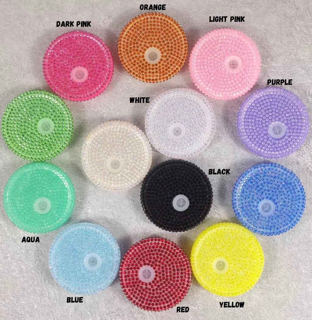 A collection of Bling Rhinestone Lids in various colors including dark pink, orange, light pink, purple, white, aqua, blue, red, and yellow, designed to fit glass cups.