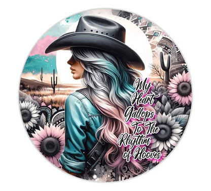 Circular coaster with a woman in a cowboy hat, desert landscape, and floral elements with text.