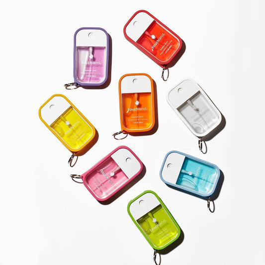 Set of colorful hand sanitizer keychain cases on a white background