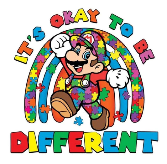 Colorful graphic with a character in a rainbow-themed outfit and 'It's Okay to Be Different' text.