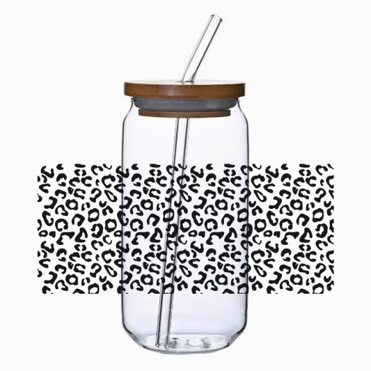 Clear tumbler with the leopard print cup wrap, bamboo lid, and straw on a white background.