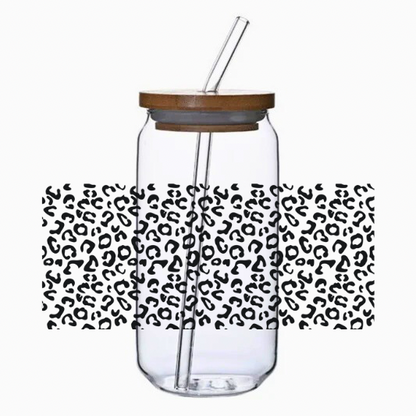 Clear tumbler with the leopard print cup wrap, bamboo lid, and straw on a white background.