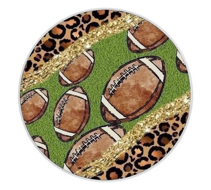 Round coaster with football pattern on a green background, featuring leopard print and gold accents.