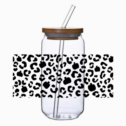 Clear glass tumbler with leopard and pumpkins print pattern, bamboo lid, and straw on a white background