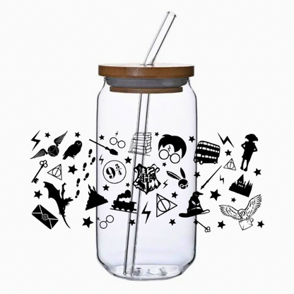 Clear glass tumbler with bamboo lid and straw featuring magic-themed illustrations on a white background.
