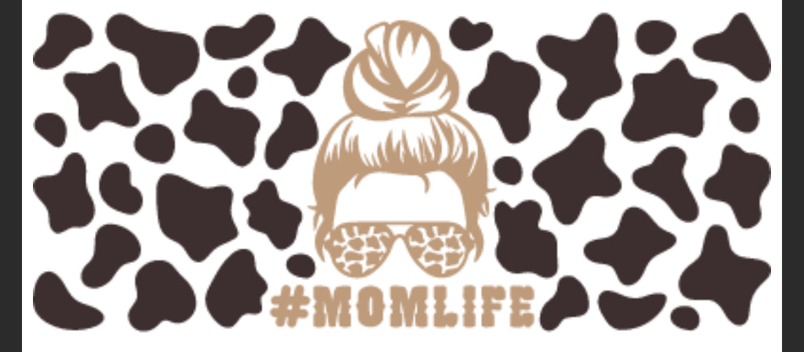 A graphic decal with a cow print background and the text '#MOMLIFE' at the top, featuring a stylized representation of a woman's headwear and glasses.
