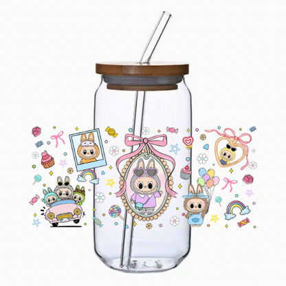 Clear tumbler with mystical cartoon characters and decorative elements on a white background