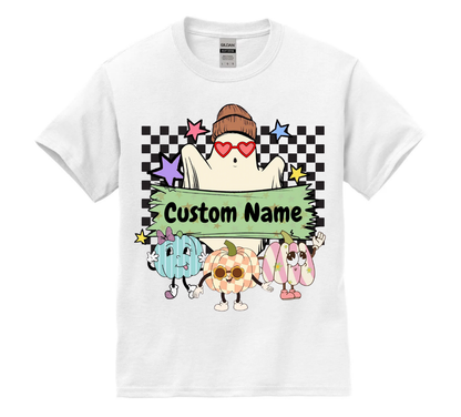 White t-shirt with colorful cartoon characters and 'Custom Name' text on a checkered background