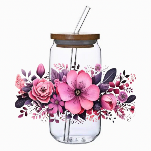 Clear tumbler with colorful floral arrangement, pink and purple flowers on a white background