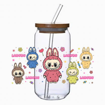 Clear tumbler with cartoon characters, flowers, stars, and candy on a white background
