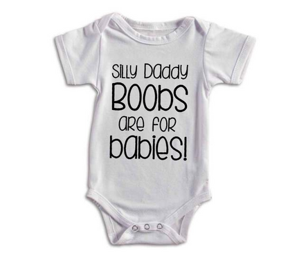 White baby onesie with text 'Silly daddy boobs are for babies!' on a white background