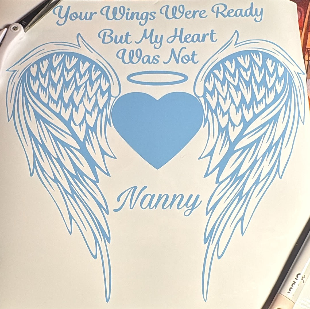 Decorative decal with angel wings, heart, and text 'Your Wings Were Ready But My Heart Was Not Nanny' on a white background.